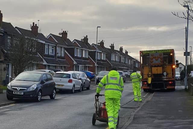 Lancashire County Council staff painting single yellow lines in Broadwood Drive, Fulwood