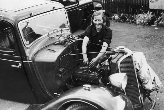 Mabel Burton, working on a car at the Old Oak garage, Hoghton, was a skilled motor engineer. This picture was taken in around 1937