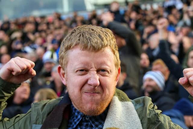 A North End fan gets up close and personal with our photographer at the final whistle.