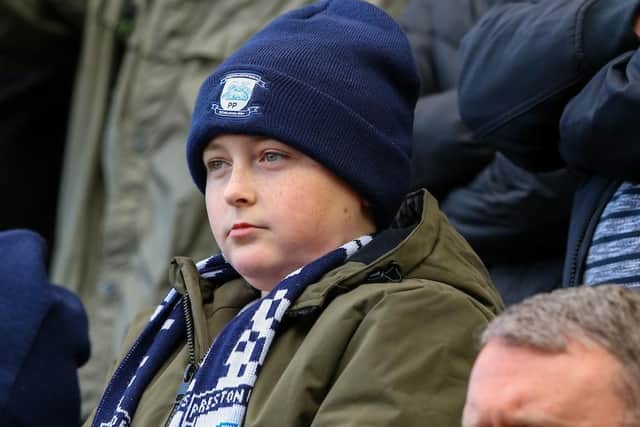 A young fan is wrapped up warm for the Saturday lunchtime kick-off