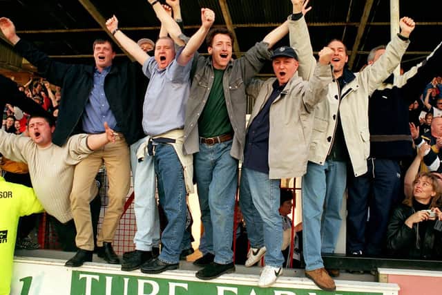 Preston fans celebrate PNE being crowned Second Division champions at Cambridge