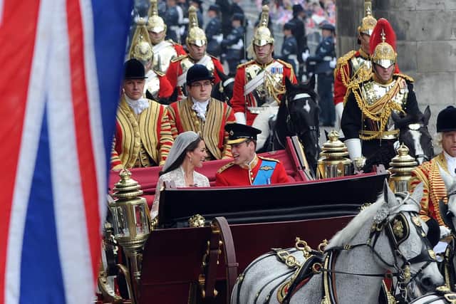 Britain's Prince William and his wife Kate, Duchess of Cambridge, travel in the 1902 State Landau carriage along the Processional Route with a Captain's Escort of the Household Cavalry