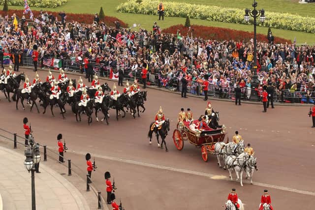 Britain's Prince William, Duke of Cambridge and his wife Kate, Duchess of Cambridge approach Buckingham Palace by carriage procession