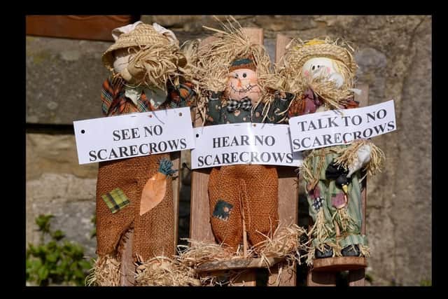 Three brass money scarecrows