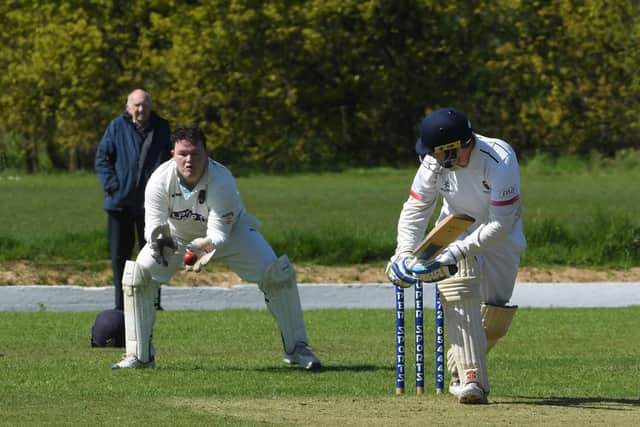 Vernon Carus skipper Bob Bridges watches a delivery go through to the wicketkeeper