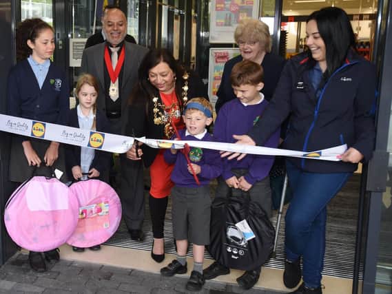 Mayor of Chorley, Coun Hasina Khan, with children from local primary schools and store staff officially opens the new store.
