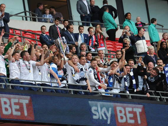 Preston North End players lift the League One play-off final trophy at Wembley in 2015
