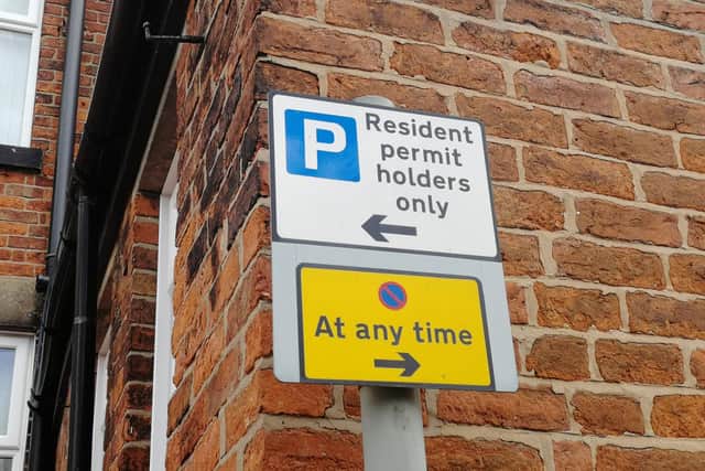 ...whereas a sign at the other end of the street indicates that parking is restricted to residents.