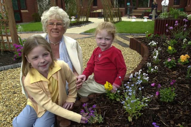 Margaret with two children in the new sensory garden in 2000