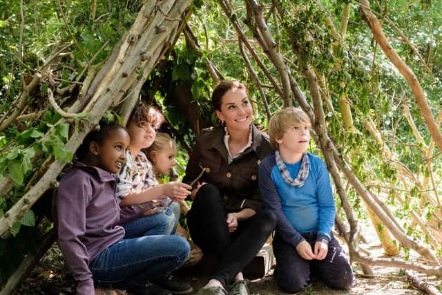 Duchess of Cambridge making a shelter with local children and Blue Peter presenter Lindsey Russell