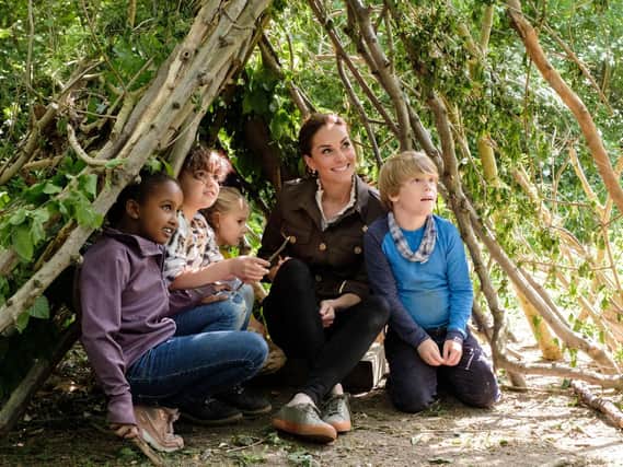 Duchess of Cambridge making a shelter with local children and Blue Peter presenter Lindsey Russell