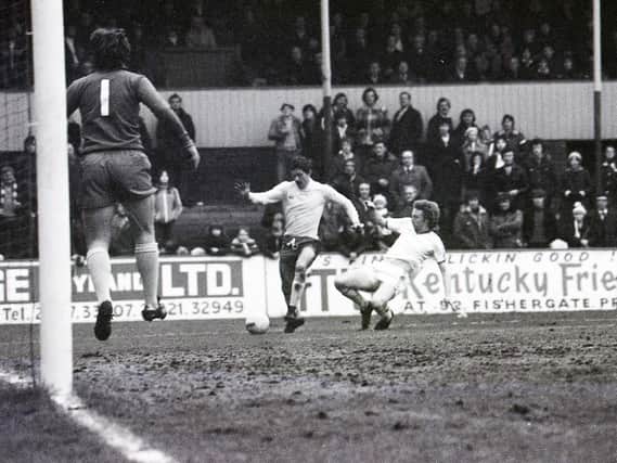 Preston striker Alex Bruce slides in to make a tackle against Carlisle at Deepdale in February 1978