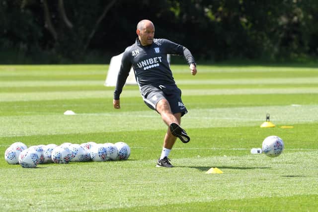 Preston manager Alex Neil passes the ball