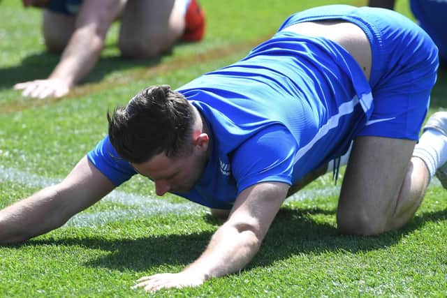 North End midfielder Alan Browne stretches out during the warm-up