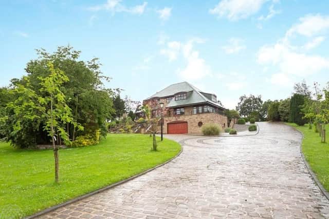 The property is accessed via a beautifully paved driveway.