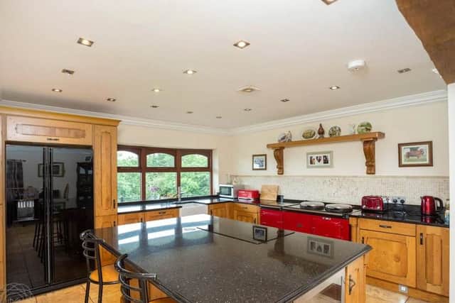 The spacious kitchen features granite work surfaces and a four oven Aga.