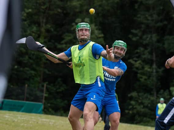 Preston skipper Tom Clarke and Striker Sean Maguire join in with a game of hurling during their Irish training camp    Picture courtesy of PNE
