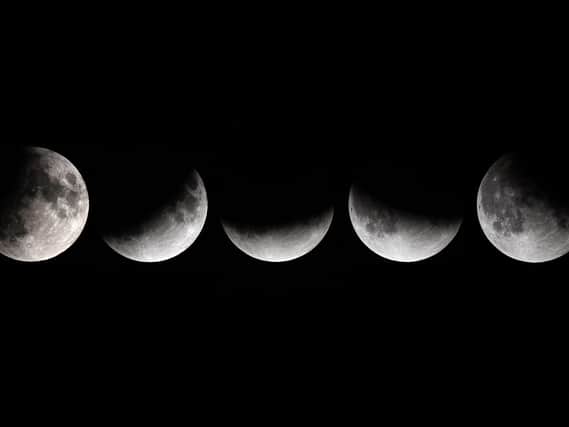 This combination of pictures shows the moon in various stages of a partial lunar eclipse as seen from Vienna
