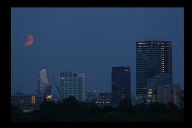 Partial lunar eclipse lights up skies 50 years on from Apollo 11 launch