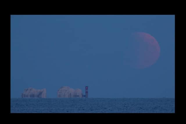 Partial lunar eclipse lights up skies 50 years on from Apollo 11 launch