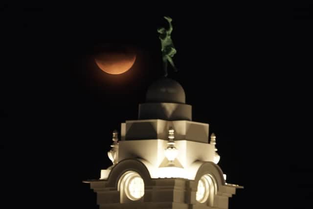 Partial lunar eclipse lights up skies 50 years on from Apollo 11 launch