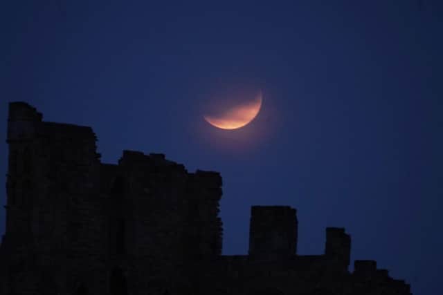 Partial lunar eclipse lights up skies 50 years on from Apollo 11 launch