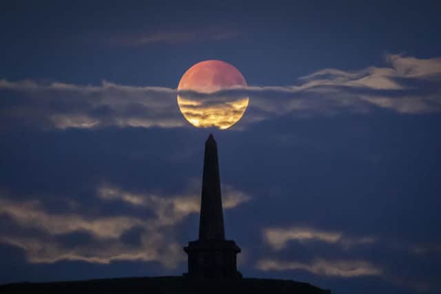 Partial lunar eclipse lights up skies 50 years on from Apollo 11 launch