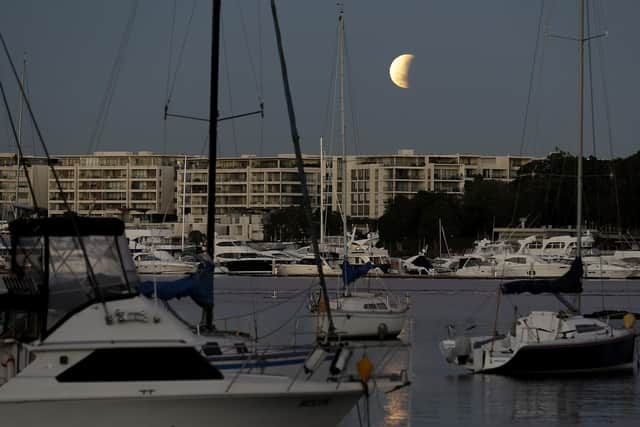 Partial lunar eclipse lights up skies 50 years on from Apollo 11 launch