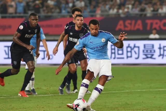 Lukas Nmecha scores a penalty for Manchester City against West Ham in the Premier League Asia Trophy