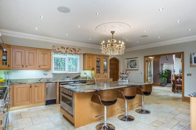 The beautiful kitchen has granite working surfaces and a range of in-built appliances.