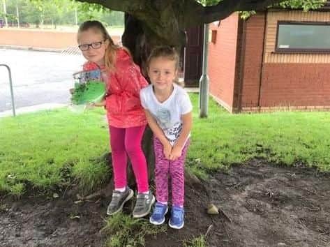 Julie Brogden's daughters, Freya, 8 (left) and Layla, 5, helping mum hide books for other lucky children to find