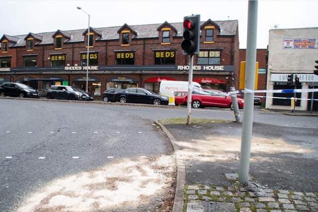Sand and grit have been spread at the scene where the car mounted the pedestrian crossing before colliding with a lamppost and traffic lights