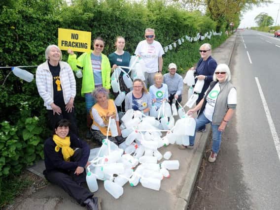 Residents and local environment groups highlight the issue of plastic pollution by creating bunting from milk bottles at the Preston New Road fracking site