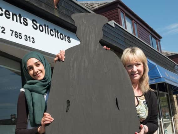 Nazreen Ali and Gail Maudsley of Vincents Solicitors, Longridge, with their 'ghost soldier'. Photo: Martin Bostock.