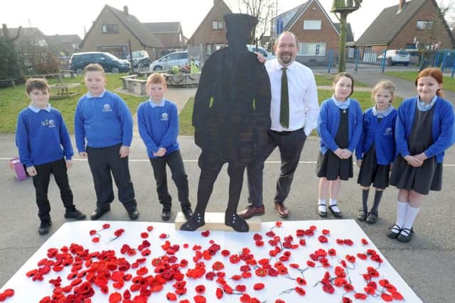 Poppies which have already been collected at Barnacre Road Primary. Pictured are pupils Barney Winder, Issac Billington, Joshua Birch, Imogen Strickland, Beth Maddock and Shannon Ball with headteacher Simon Wallis.