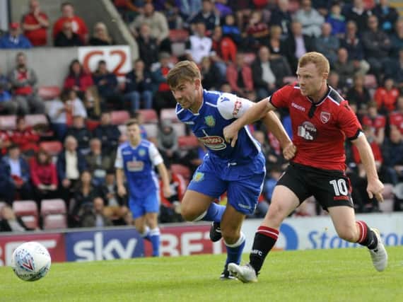 Ryan Winder and Adam Campbell battle for the ball during last July's game at the Globe Arena.