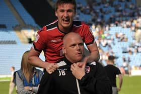 Aaron McGowan celebrates Morecambe surviving on the final day with boss Jim Bentley