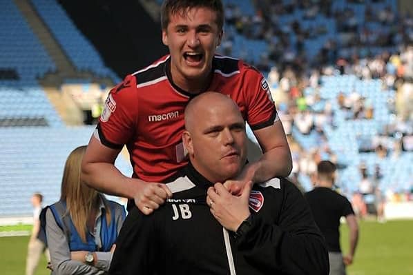Aaron McGowan celebrates Morecambe surviving on the final day with boss Jim Bentley