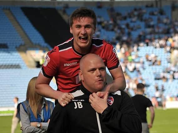 Aaron McGowan celebrates Morecambe surviving on the final day with boss Jim Bentley
