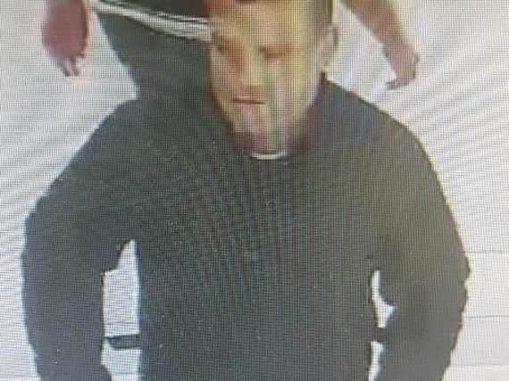 A woman had her purse stolen after she was distractedby a man at a Leyland supermarket, say police.