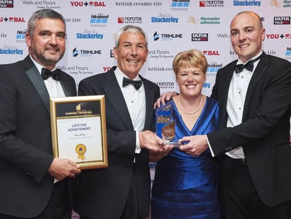 Paul Luff, chair of The Tile Association presenting the award to Paul Kelly, with his wife Rona and son Mark