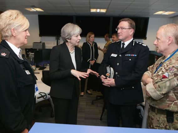 Left to Right: Silver Commander Greater Manchester Police Superintendent Donna Allen, Prime Minister Theresa May, Gold Commander Greater Manchester Police Chief Constable Ian Hopkins, and Lieutenant Colonel Ray Carolin after the Manchester Arena attack.