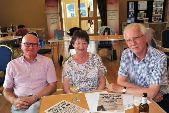 from left, Ray Armstrong, Linda Butterworth and John Butterworth at the Auctioneers event at Broughton and District Club for Methodist Action