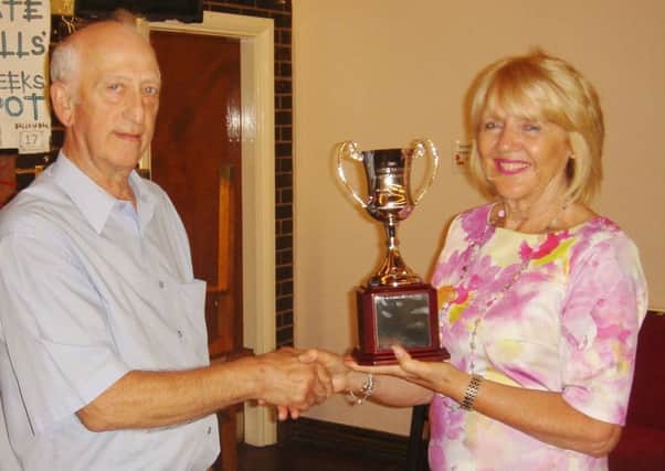 Barbara Taylor presens the award to Ralph Cooper, secretary of Newman College FC