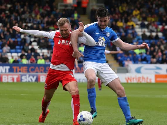 Andrew Hughes (right) in action for Peterborough against Fleetwood