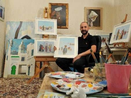 Mohammed Ehlalouch with some of his artwork