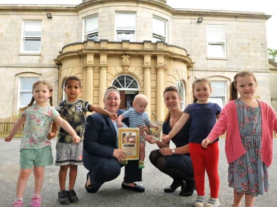 Staff and children at Busy Bees Ashton House nursery in Preston
