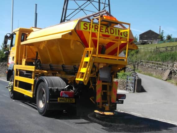 Lancashire County Council's gritters are out in the stifling heat... to spread granite dust to stop the road surface melting