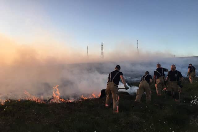 Firefighters tackling a moorland fire at Winter Hill near Rivington.