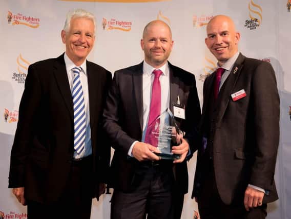 Dave Clegg, (centre) was presented with an award at The Fire Fighters Charitys Spirit of Fire Awards in London
